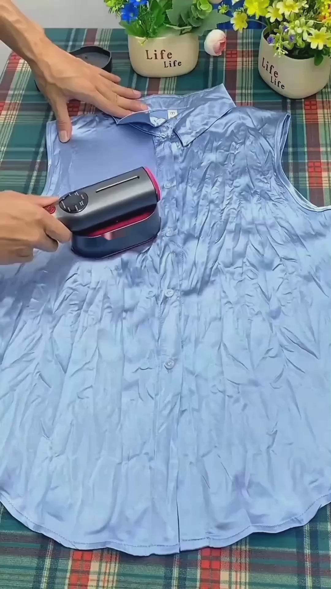 Velora mini steam iron removing wrinkles from a shirt